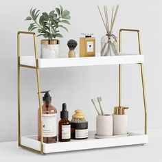 a shelf with some bottles, soaps and other bathroom items on it next to a potted plant