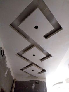 the ceiling is made up of square and rectangle shapes with holes in each section