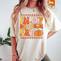 Step into the fall spirit with this adorable "In My Pumpkin Era" T-shirt! Made from soft, cozy fabric, this tee is perfect for embracing all things autumn--pumpkin spice, cozy vibes, and harvest fun. Featuring a playful design, it's great for pumpkin patch visits, fall festivals, or casual outings. Show off your love for the season and make every autumn day a little cozier with this trendy pumpkin-themed shirt! How to Order 1. Select Size: Choose the right size from the size chart provided in the photos. 2. Choose Color & Style: Select your preferred color. Decide between a crewneck or a hooded style for sweatshirts. 3. Pick Thread Color: Review the thread color options shown in the photos and specify your choice in the customization box. Need Customization or Help? If you need any customi Fall Graphic Tee, Fall Festivals, Pumpkin Spice Shirt, Fall Graphic, Pumpkin Season, Cozy Fabric, Pumpkin Seasoning, Pumpkin Theme, Thanksgiving Gift