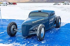 a blue toy car is parked in the snow