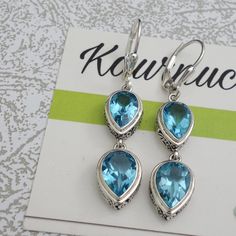 Swiss Blue Topaz Beautiful Earrings. Nice size Stones. Lovely Ornate handwork on bezel Length 1.70 inch Stone Size 10x7mm 9x6mm Silver Topaz Earrings With Gemstone Accents, Blue Topaz Teardrop Earrings For Anniversary, Sapphire Blue Topaz Earrings For Pierced Ears, Topaz Anniversary Earrings With Gemstone Accents, Topaz Earrings For Pierced Ears, Nickel Free Blue Topaz Drop Earrings, Nickel-free Blue Topaz Dangle Earrings, Blue Topaz Gemstone Dangle Earrings, Blue Topaz Dangle Earrings With Gemstone