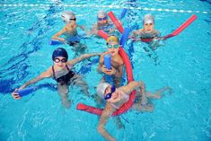 several people in swimming suits and goggles are floating on rafts