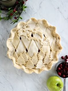 an apple pie sitting on top of a table next to some cranberry sauce