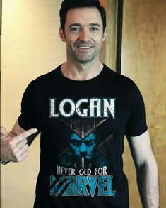 a man wearing a t - shirt that says logan never old for marvel