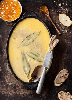 a pan filled with food next to two spoons