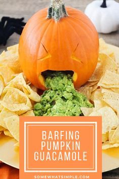 a plate with chips, guacamole and a pumpkin