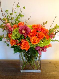 a vase filled with orange and pink flowers