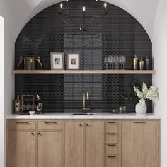 a kitchen with wooden cabinets and black tile backsplash, along with white walls