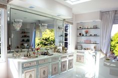 an image of a large bathroom setting with sink and mirror in the middle, all white