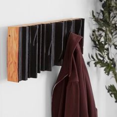 a coat rack is hanging on the wall