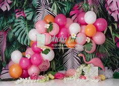 pink, orange and white balloons with flamingos on the side at a tropical themed birthday party