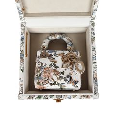 This Limited Edition Christian Dior Mirco Lady Dior Bag is in White/Multicolored Embroidered Calfskin with Light Gold Hardware, features butterfly and flower garden motif with 3D-like embroidered flowers and butterflies all over bag, tonal stitching, DIOR logo charm hanging from bag, two flat leather top handles, flap closure and removable shoulder strap. The Micro Lady Dior also comes in a White Multicolored Calfskin Leather Small Trunk. The Trunk also features a butterfly and floral motif in c Lady Dior Limited Edition, Luxury Elegant Floral Embroidered Bag, Rare Lady Dior Bag, Dior Butterfly Bag, Christian Dior Floral Bag, Dior Embroidered Bag, Small Lady Dior My Abcdior Bag, Dior Limited Edition Bag, Dior Purse