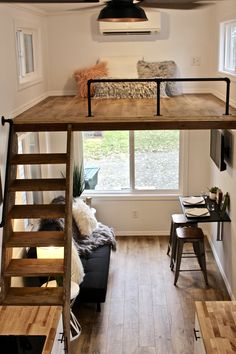 a loft bed with stairs leading up to it