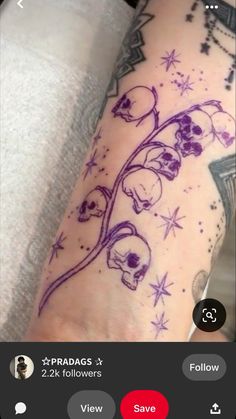 a woman's arm with skulls and stars on it, while she is wearing a purple tattoo