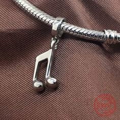 Discover your inner rockstar and make a statement with this stylish Music Note Dangle Pendant. With its striking design and elegant metal construction, it's the perfect addition to any outfit. Show off your unique style and wear it on your charm bracelet or add it to a necklace for a personalized touch. Compatible With: Bolenvi Bead Charm Bracelets Bolenvi Moments O Pendants Bolenvi Bead Charm Necklaces Also Compatible: Pandora, Biagi, Troll, Chamilia, Persona, Ohm, Kay's Charmed Memories and si Leather Charm Bracelets, Pandora Bracelet Charms, Musical Note, Pandora Charm, Music Note, Bead Charm Bracelet, Pandora Bracelet, Sterling Silver Charm, Music Notes