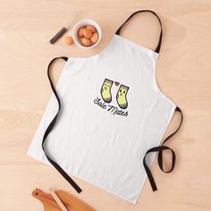 a white apron with two socks on it next to eggs and utensils,