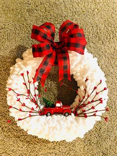 a christmas wreath with a red truck on it