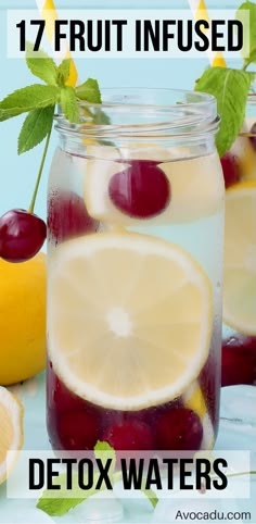 a jar filled with lemons, cherries and water