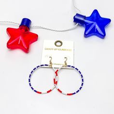 Red, White, And Blue Beaded Circle Earrings. Pictured on a white background with a red and blue star above the earrings. Blue Patriotic Earrings For Independence Day, Patriotic Blue Earrings For Independence Day, Patriotic Beaded Earrings For 4th Of July, Adjustable Blue Earrings For 4th Of July, Blue Jewelry For 4th Of July Beach Day, Red Patriotic Beaded Earrings, Patriotic Blue Beaded Earrings, Patriotic Multicolor Summer Jewelry, Patriotic Jewelry For 4th Of July Beach Occasion