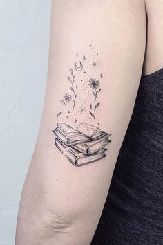 a woman's arm with a book tattoo on the left side of her arm