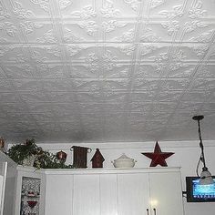 the ceiling in this kitchen is decorated with white embossings and red stars