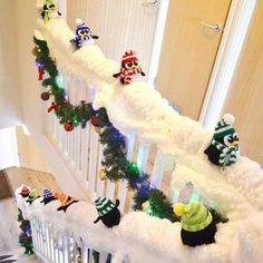 christmas decorations on the banisters and railing of a house with snow covered stairs