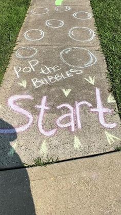 a sidewalk with chalk writing on it that says, pop the bubbles start and end