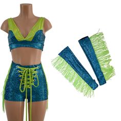 "This set has sparkle, glow and FRINGE! Created in our turquoise on black shattered glass fabric, with Neon Lime Holographic grim, and Neon Lime fringe.  You can purchase the set with or without the matching fingerless gloves. Includes: Starlette bralette Sailor shorts with front laceup and hip fringe Optional fingerless gloves with thumbhole and fringe Made to order, ships out within five days of purchase. Womens Sizing (See below for instructions on where measurements should be taken) Extra Small: Bust 31\"-32\" / Waist 24\"-25\" / Hips 33\"-35\" Small: Bust 33\"-34\" / Waist 26\"-28\" / Hips 36\"-37\" Medium: Bust 35\"-37\" /Waist 28\"-31\" / Hips 38\"-40\" Large: Bust 39\"-41\" / Waist 32\"-34\"/ Hips 41\"-43\" Extra Large: Bust 42\"-44\" / Waist 35\"-37\" / Hips 44\"-46\" XXL: Bust 46 Festival Fringe Shorts, Blue Rave Chaps, Blue Fringe Skirt, Spring High-waist Fringe Shorts, High-waist Cotton Fringe Shorts, Sailor Shorts, Fun Clothing, Short Fringe, Shattered Glass