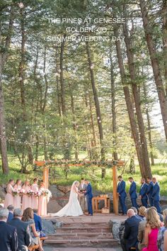 a wedding ceremony in the woods with people sitting on steps and looking at each other