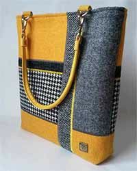 a yellow and gray bag with black and white checkered fabric