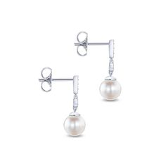 Set in luxurious gold, these classic dangle earrings feature a duo of glossy cultured pearls. Glinting with a total weight of 0.06 carats, round cut diamonds dance across the white gold frame for a delicate touch of shimmer. Earrings dangle just over 3/4 an inch. Pearls measure approximately 7mm wide. Due to the organic nature of mother of pearl, there may be minor variances in color, size and shape from the image Includes earring box Ships fully insured to point of delivery Drop Diamond Earrings, Gabriel Jewelry, Earring Box, Yellow Gold Earrings, Jewelry Appraisal, White Gold Set, Yellow Gold Earring, Shop Engagement Rings, Gold Earrings Dangle