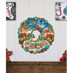 a christmas wreath is hanging on the wall next to other holiday decorations and decor items