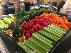 a tray filled with vegetables on top of a kitchen counter