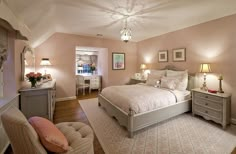 a bedroom with pink walls and white furniture