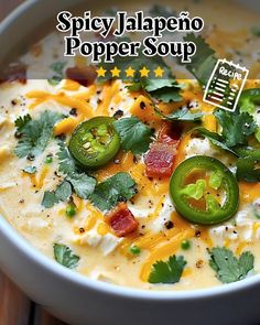 a bowl of soup with cheese, jalapenos and green peppers on top