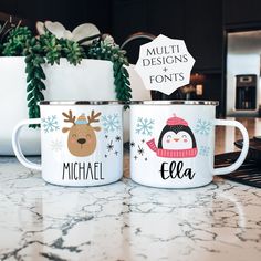 two personalized coffee mugs sitting on top of a counter