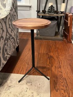 a wooden table sitting on top of a hard wood floor next to a gray chair