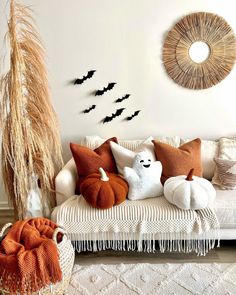 a living room filled with lots of pillows and decor on top of a white couch