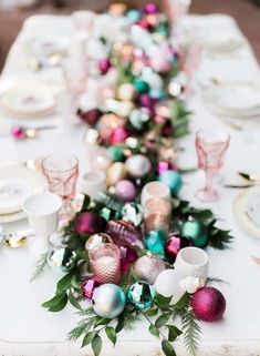 a long table is decorated with ornaments and greenery