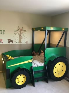 a child's bed made to look like a tractor with lights on the wheels