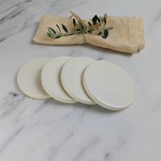 four white plates sitting on top of a marble counter