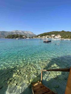 clear water with boats in the distance