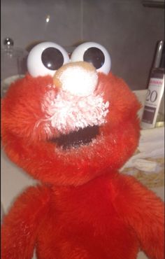 a red stuffed animal with big eyes and googly eyes