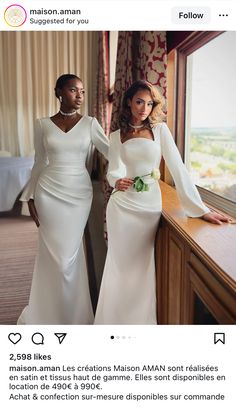 two women in white dresses standing next to each other, one wearing a long sleeved dress