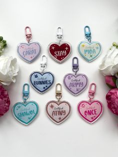 six heart shaped charms with words on them