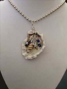 a necklace with a shell and starfish on it