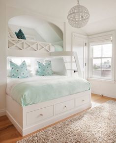 an instagramted photo of a bedroom with white furniture and blue pillows on the bed