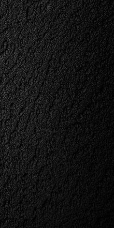 a black textured wall is shown in this image