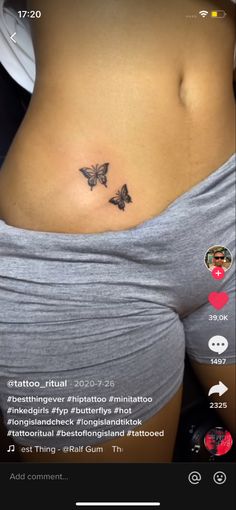 a woman's stomach with two butterflies on it