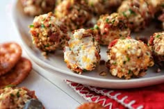 a white plate topped with meatballs covered in cheese